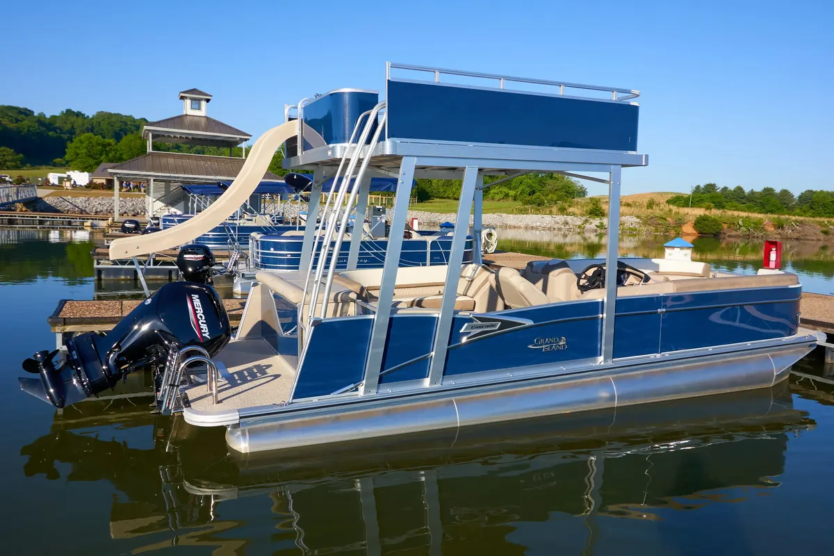 Pontoon boat on Watts Bar Lake at sunset with the Tennessee National marina in the background